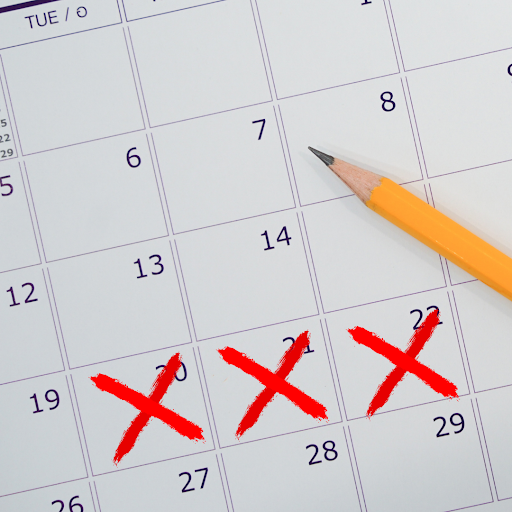 part of a calendar with a pencil on it and three dates crossed out with red x