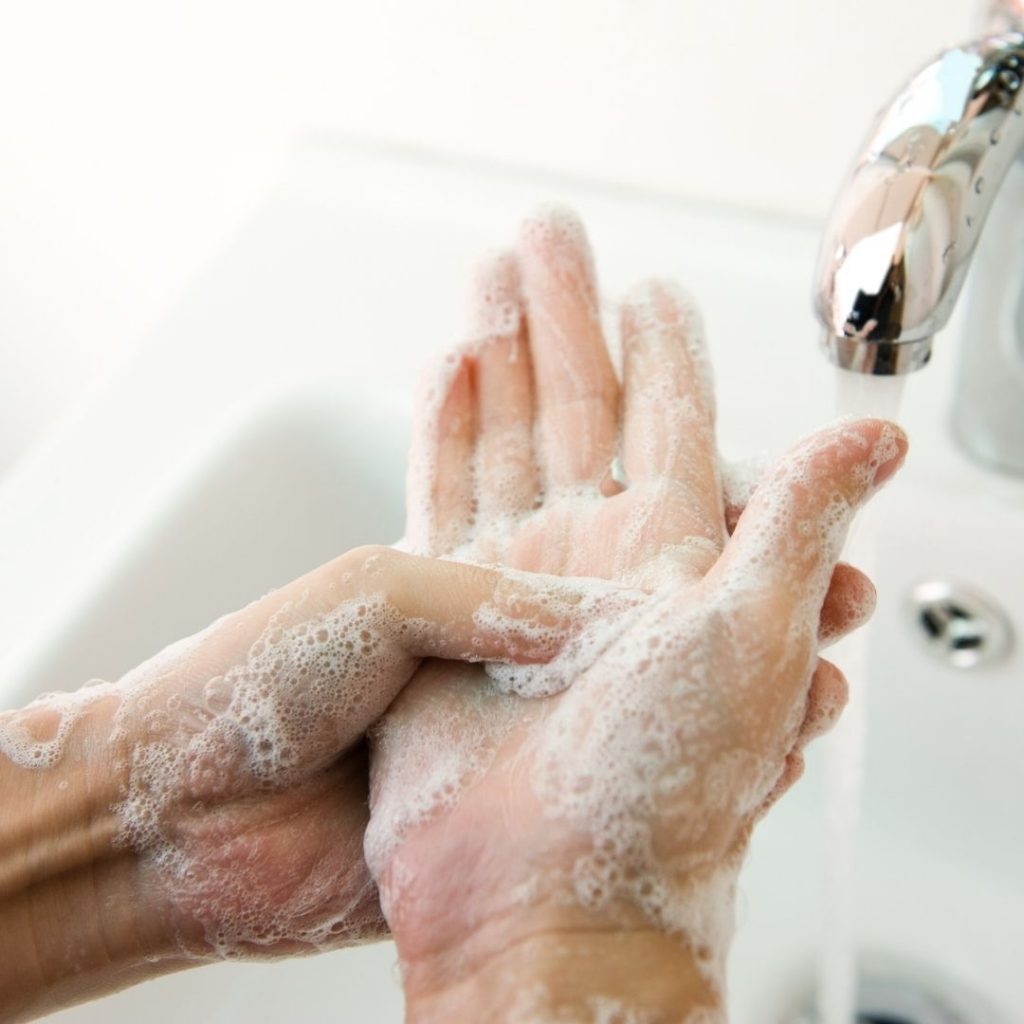 person with soapy hands, washing hands