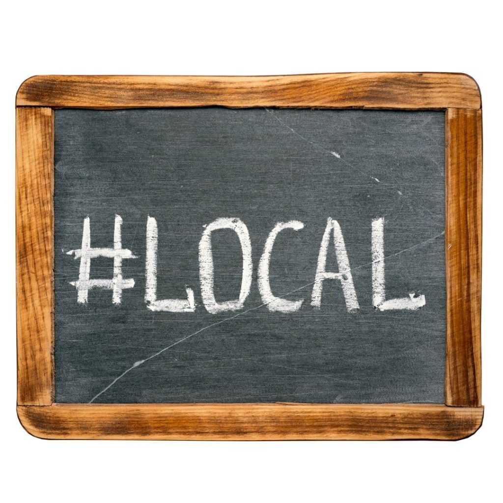 hand chalkboard with #local written on it