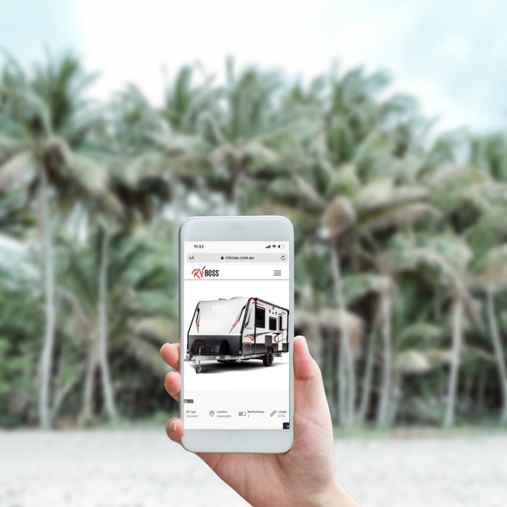 hand holding a smart phone with a RV Boss listing on smartphone screen with blurred palm tree beach background